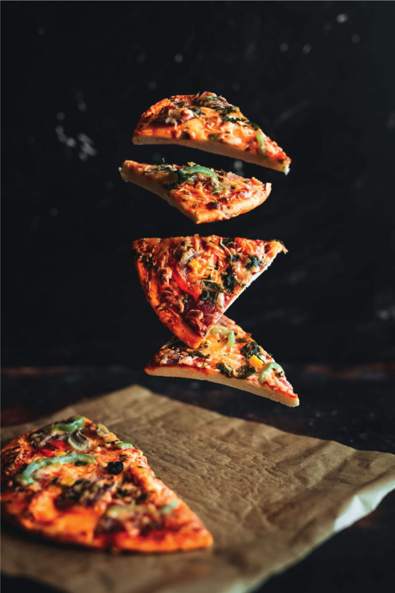 Levitating pizza on black background